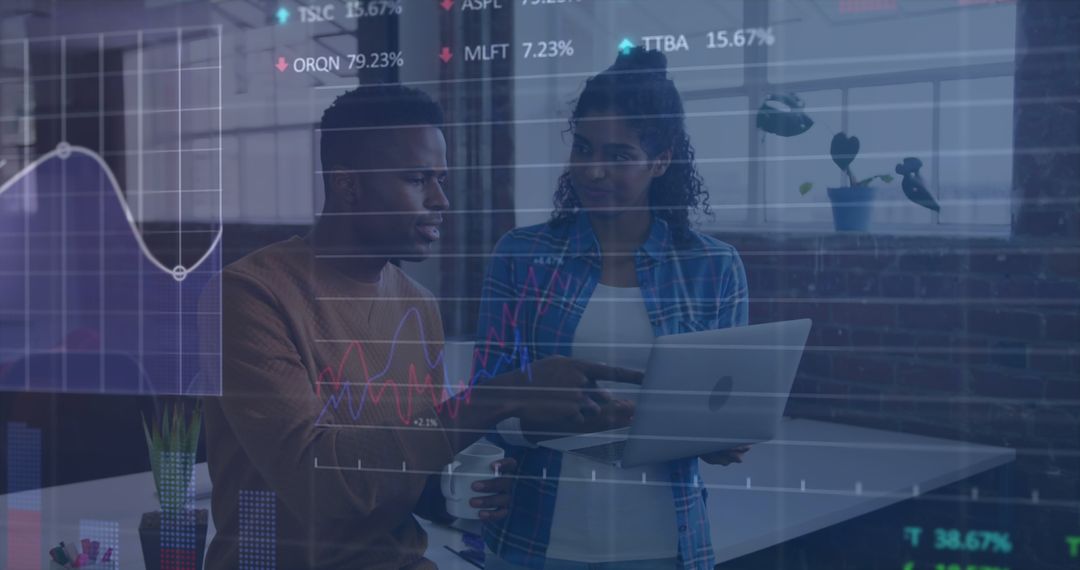 Diverse Colleagues Analyzing Data on Laptop with Overlaid Financial Graphs