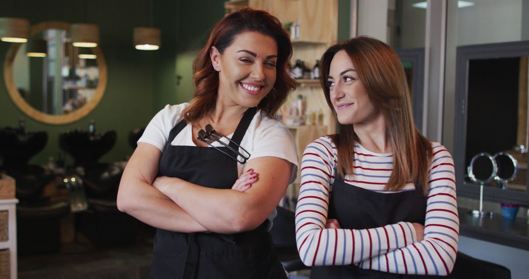 Two Female Hairdressers Wearing Aprons at Salon - Free Images, Stock Photos and Pictures on Pikwizard.com