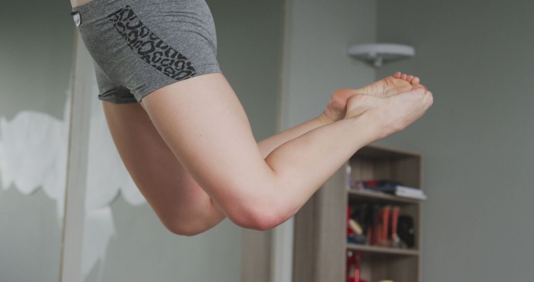 Person Jumping Indoors Wearing Grey Shorts - Free Images, Stock Photos and Pictures on Pikwizard.com