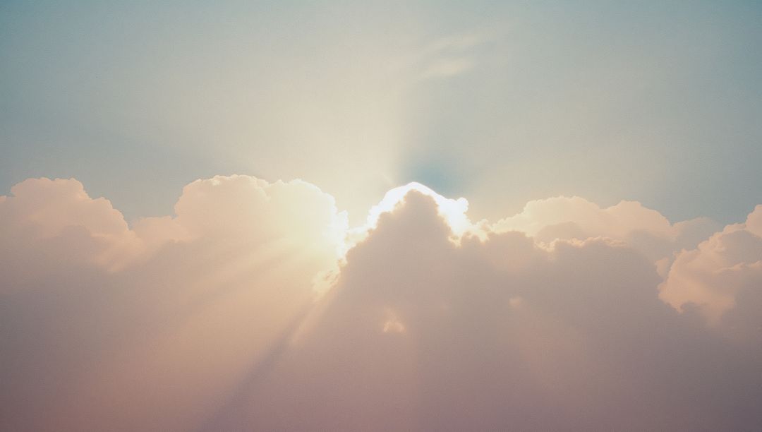 Sunlight Radiating Through Cumulus Clouds At Sunrise
