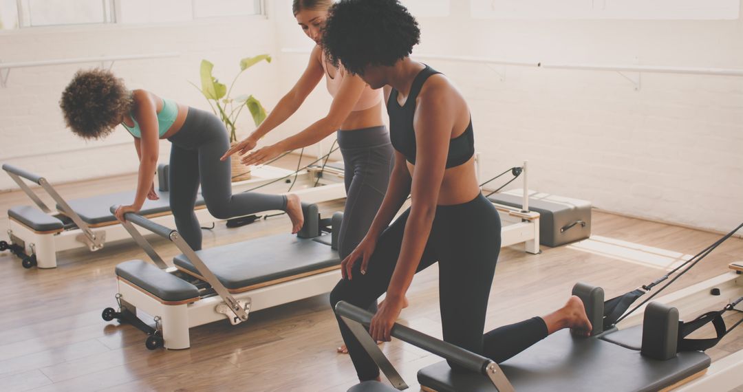 Women Engaging in Pilates Class with Instructor's Guidance