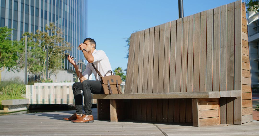 Businessman Waiting on Wooden Bench Drinking Coffee - Free Images, Stock Photos and Pictures on Pikwizard.com