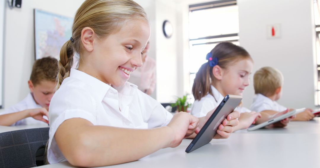 Young Students Using Tablets in Classroom Smiling and Engaging - Free Images, Stock Photos and Pictures on Pikwizard.com