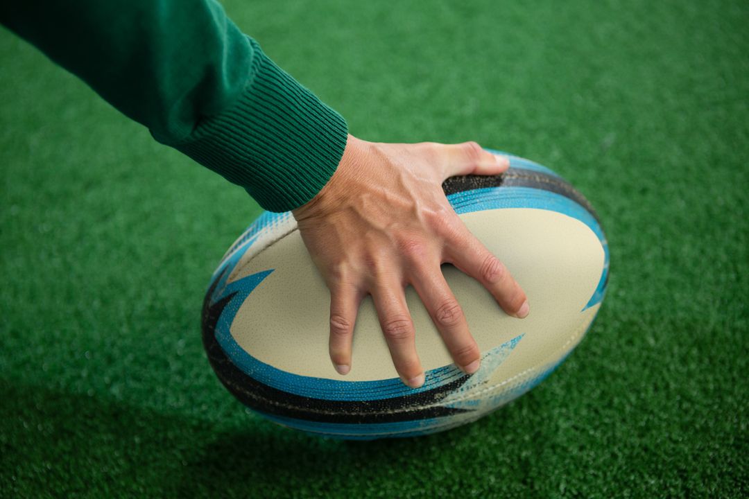 Cropped hand holding rugby ball - Free Images, Stock Photos and Pictures on Pikwizard.com