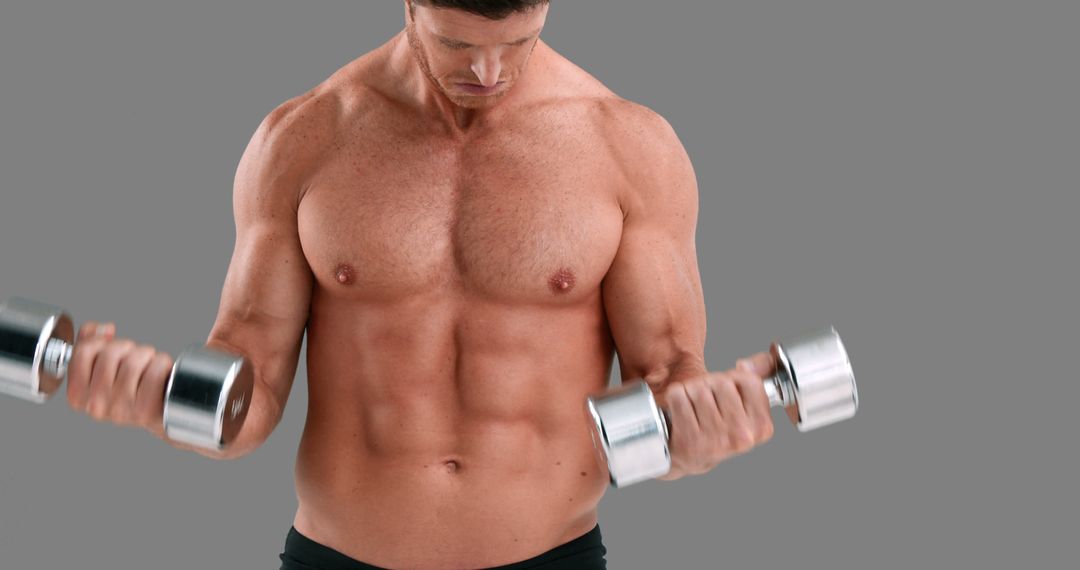 Muscular Man Lifting Dumbbells on Gray Background - Free Images, Stock Photos and Pictures on Pikwizard.com