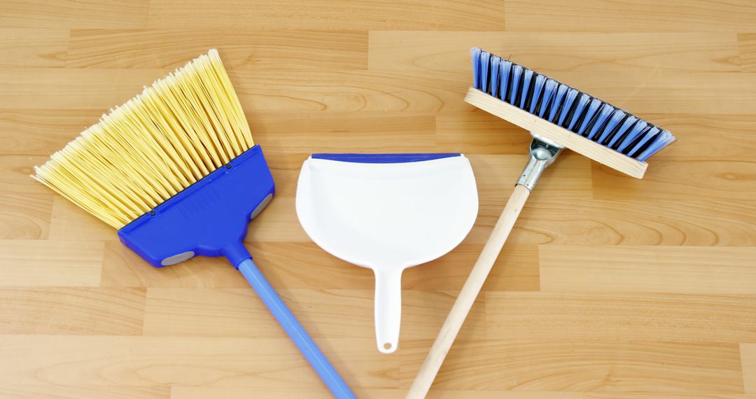 Various Cleaning Tools Featuring Brooms and Dustpan on Wooden Floor - Free Images, Stock Photos and Pictures on Pikwizard.com