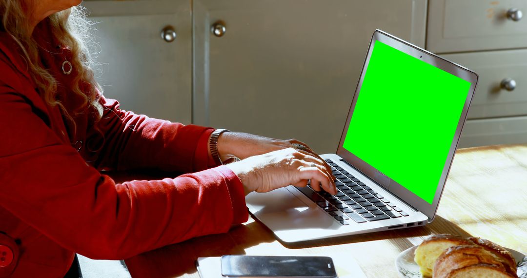 Woman Typing on Laptop with Green Screen at Wooden Table - Free Images, Stock Photos and Pictures on Pikwizard.com