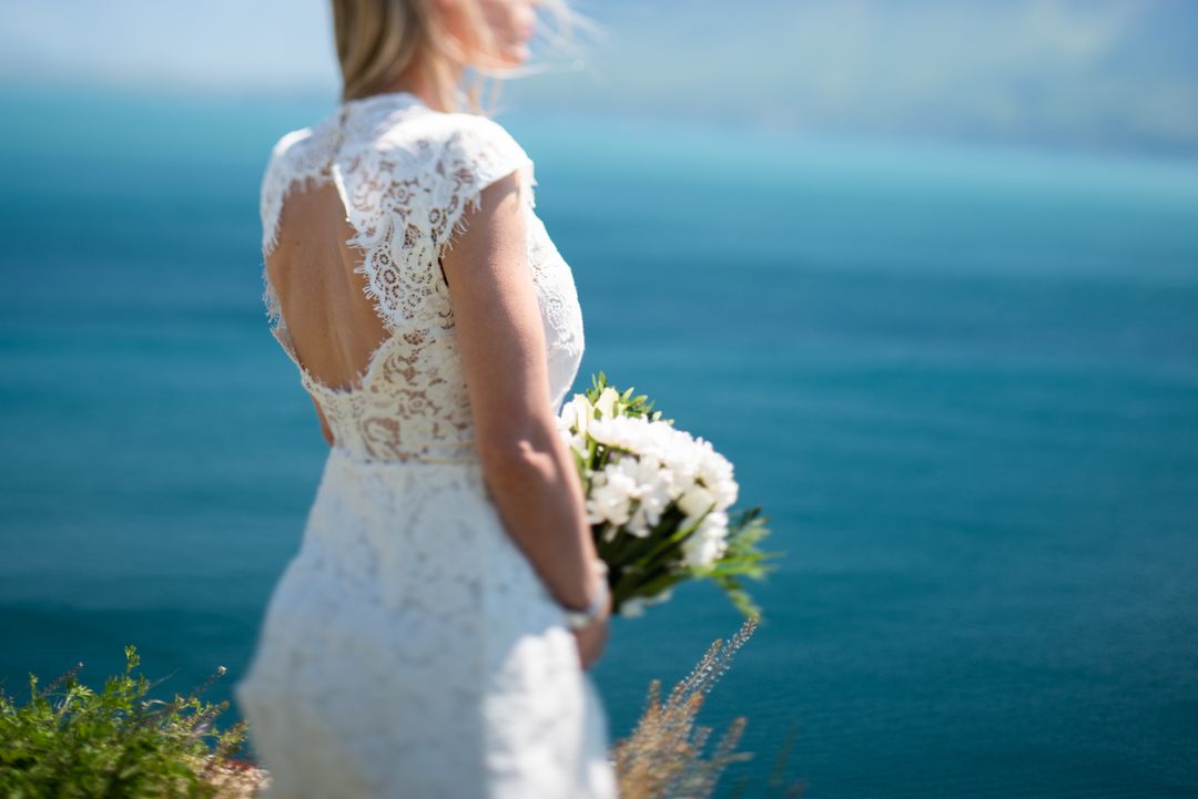 Bride Holding Bouquet by Ocean Overlook