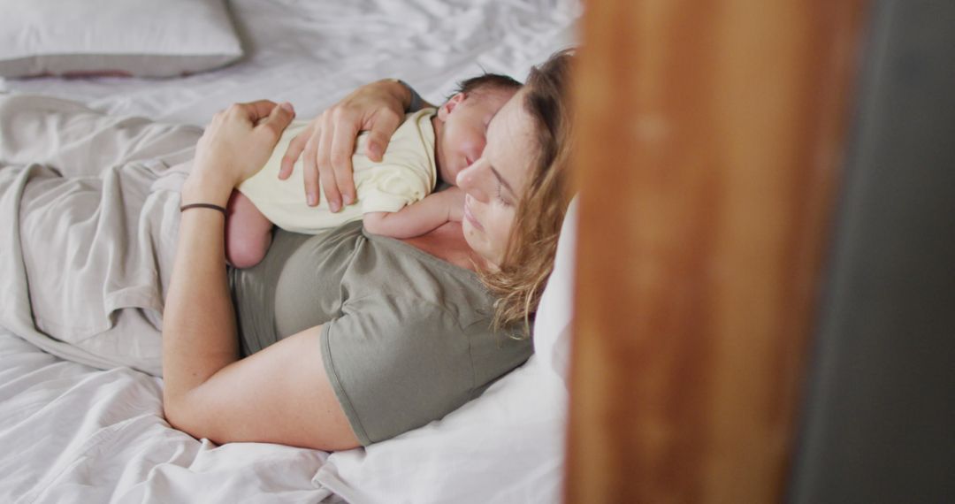 Image of happy caucasian mother sleeping on bed with newborn baby - Free Images, Stock Photos and Pictures on Pikwizard.com