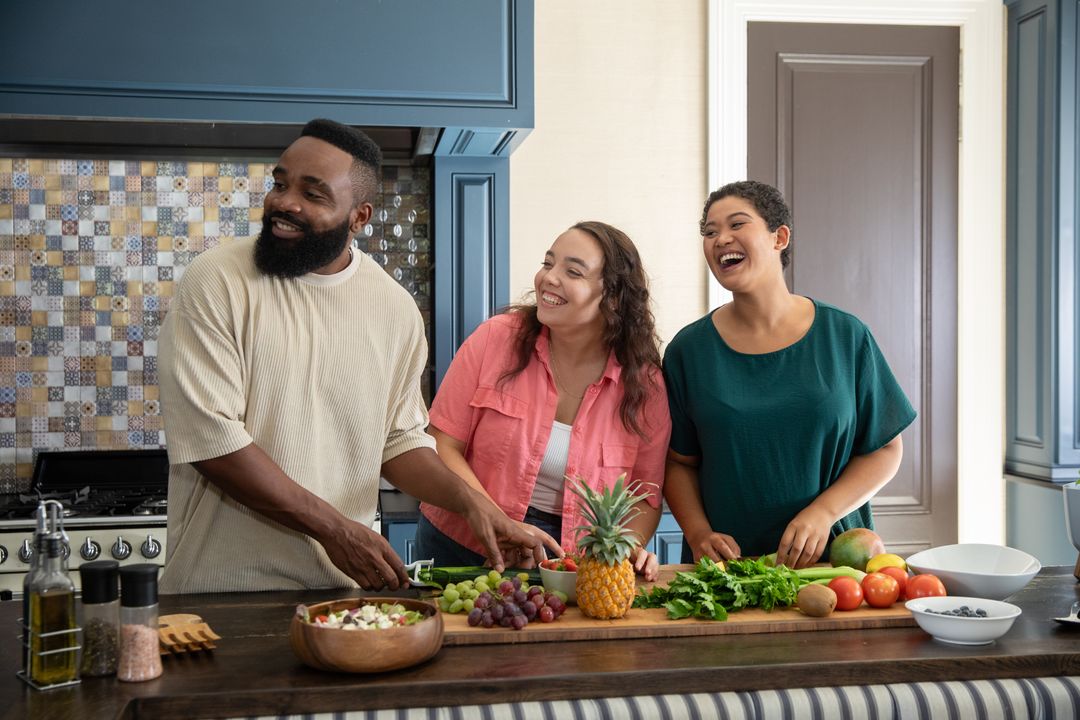 Diverse Group of Friends Enjoying Time Preparing Fresh Vegetables in Kitchen