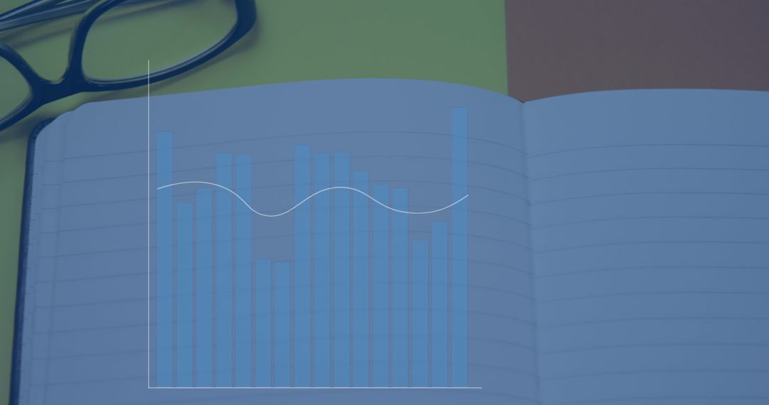 Graph Overlay on Notebook with Glasses on Desk