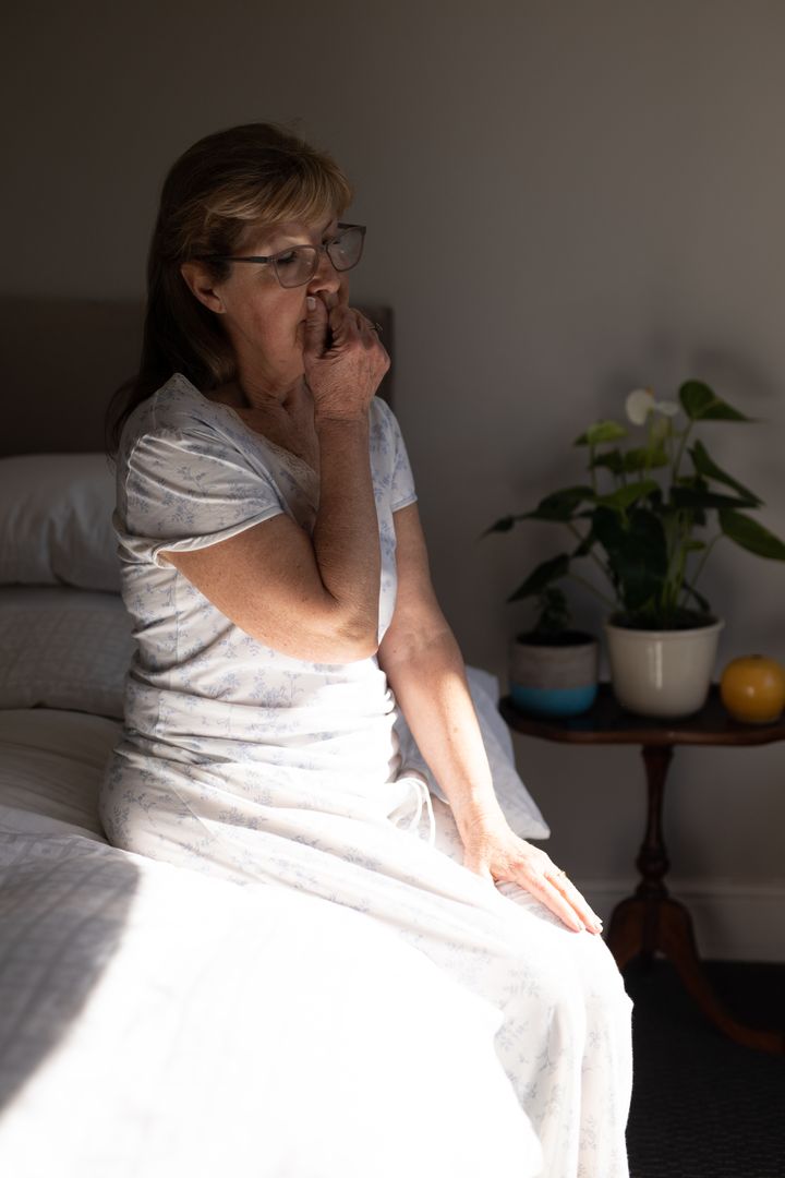 Senior Woman Coughing in Bedroom During Quarantine - Free Images, Stock Photos and Pictures on Pikwizard.com