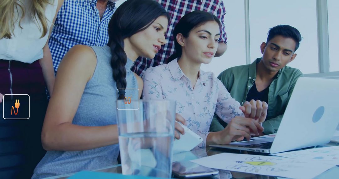 Diverse Team Collaborating Around Laptop on Business Project