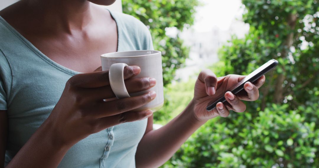 Woman Drinking Coffee and Using Smartphone Outdoors - Free Images, Stock Photos and Pictures on Pikwizard.com