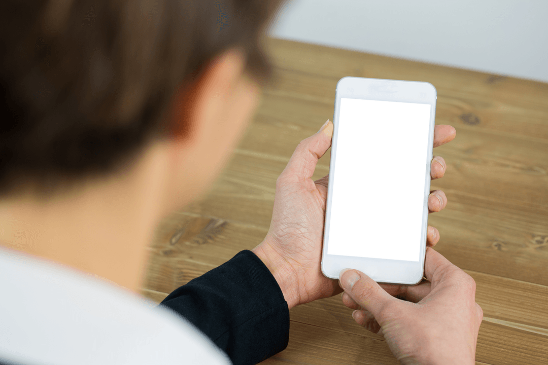 Businesswoman Using Smartphone at Desk with Blank Display