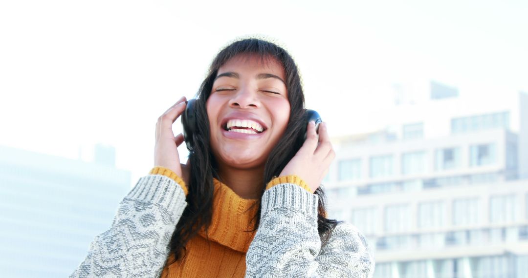 Happy Woman Enjoying Music on Headphones Outdoors - Free Images, Stock Photos and Pictures on Pikwizard.com