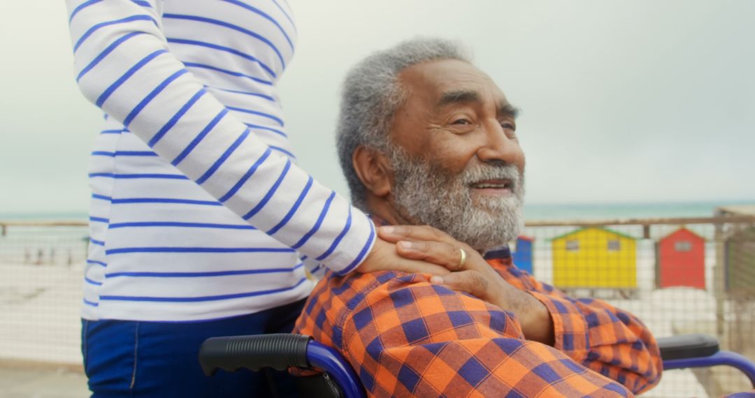 Smiling Disabled Man Enjoying Outdoors with Caring Companion