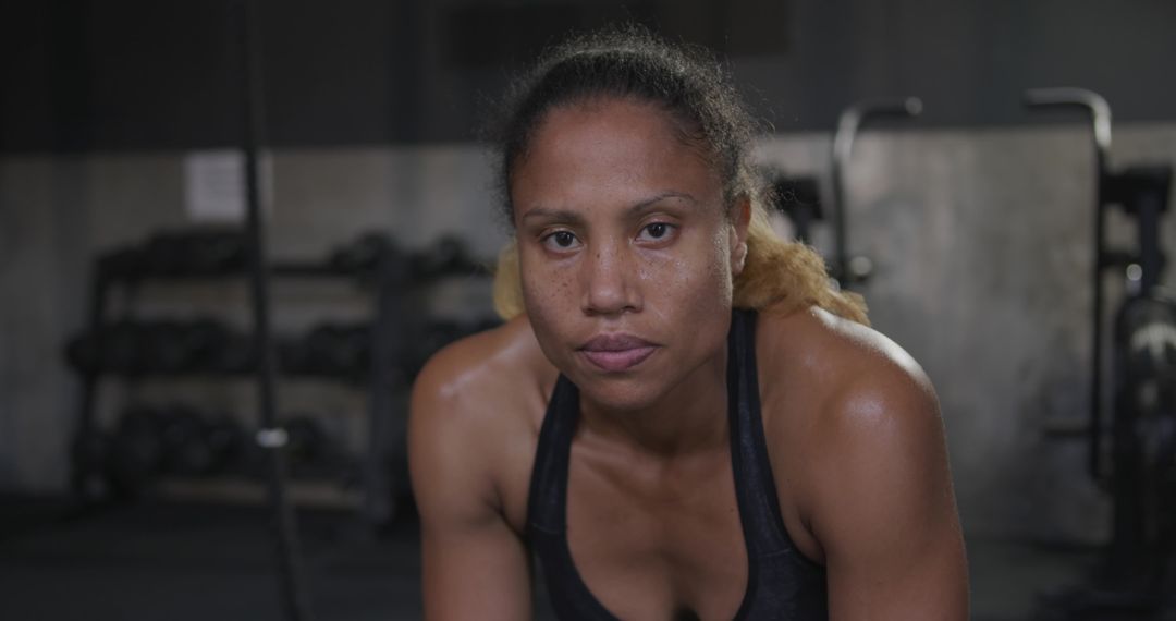 Determined Athlete Resting in a Gym Environment