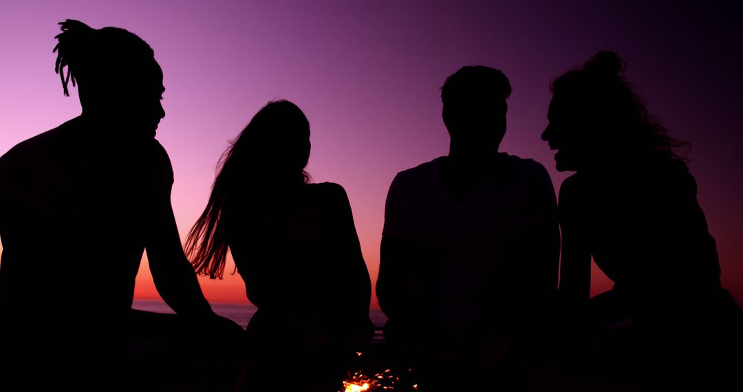 Four Friends Socializing Outdoors at Sunset Silhouette - Free Images, Stock Photos and Pictures on Pikwizard.com