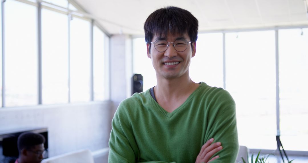 Confident Asian Businessman in Modern Workspace Smiling Confidently