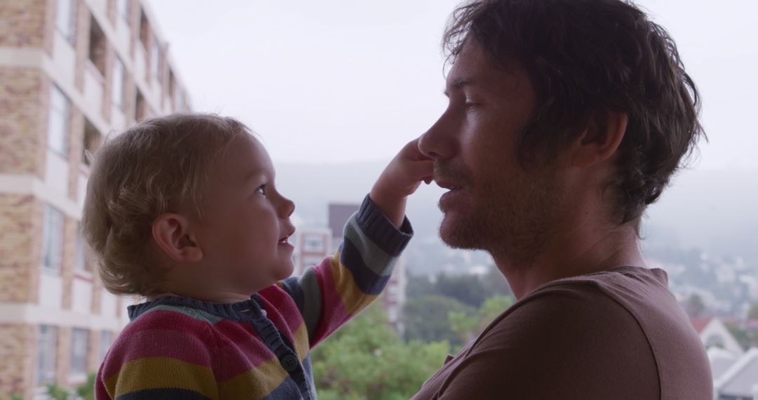 Father Playing with Daughter on Balcony During Leisure Time