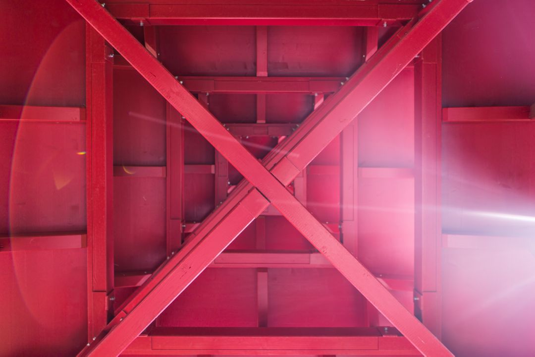 Abstract Geometric Pattern of Red Steel Beams with Lens Flare - Free Images, Stock Photos and Pictures on Pikwizard.com