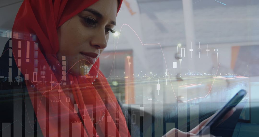 Businesswoman in Red Hijab Using Smartphone with Financial Data Overlay