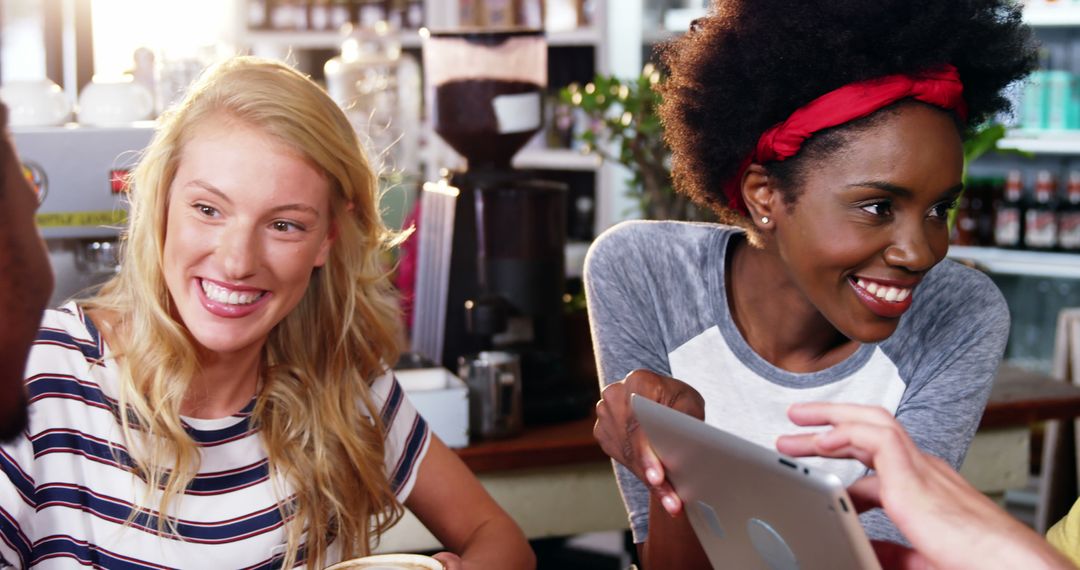 Friends Connecting at a Coffee Shop with Tablet - Free Images, Stock Photos and Pictures on Pikwizard.com