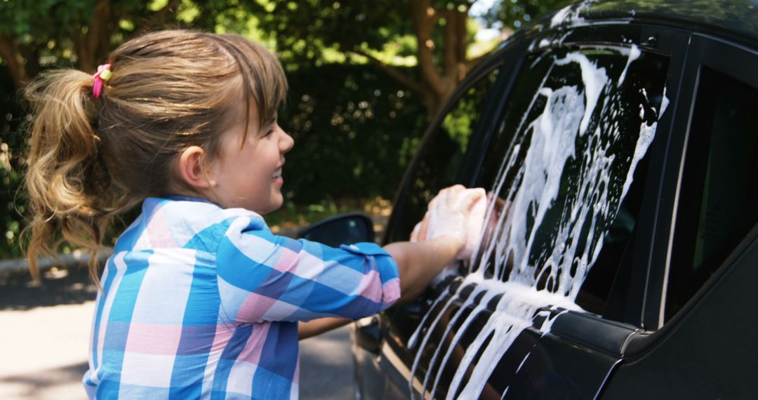 Young Girl Enthusiastically Washing Car with Soap Suds - Free Images, Stock Photos and Pictures on Pikwizard.com