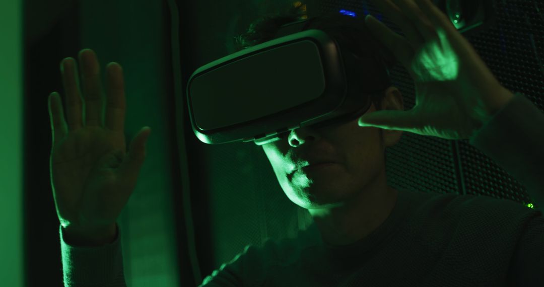 Person Using Virtual Reality Headset with Green Lighting - Free Images, Stock Photos and Pictures on Pikwizard.com