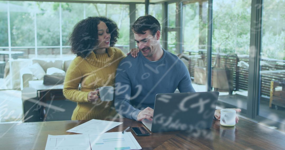 Diverse Couple Collaborating Using Laptop and Geometry