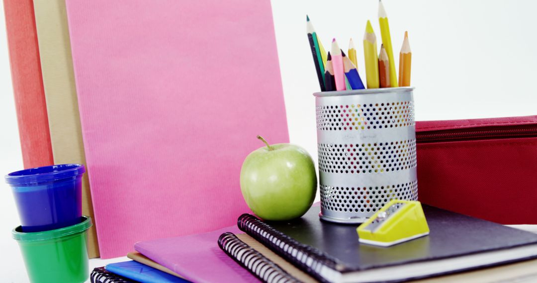 Colorful School Supplies with Notebooks and Apple - Free Images, Stock Photos and Pictures on Pikwizard.com