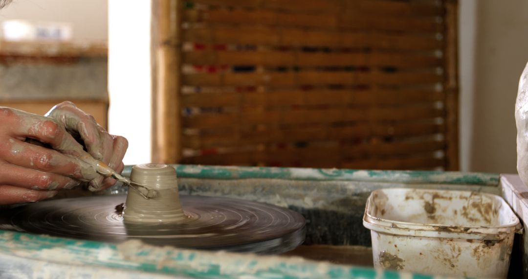Potter's Hands Crafting with Clay in Studio Workshop