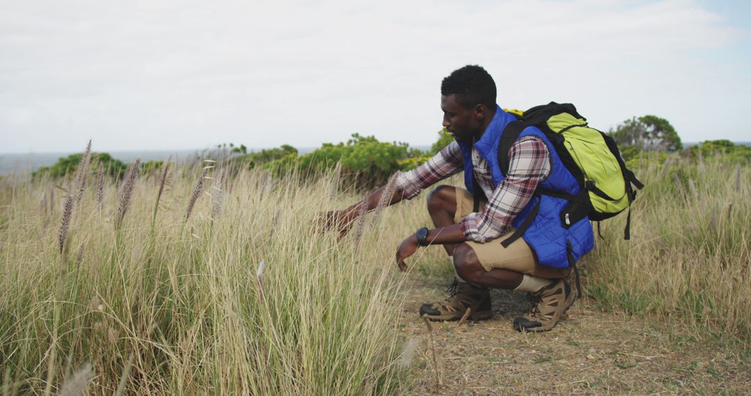 Man Exploring Nature Hiking Trail In Countryside Landscape