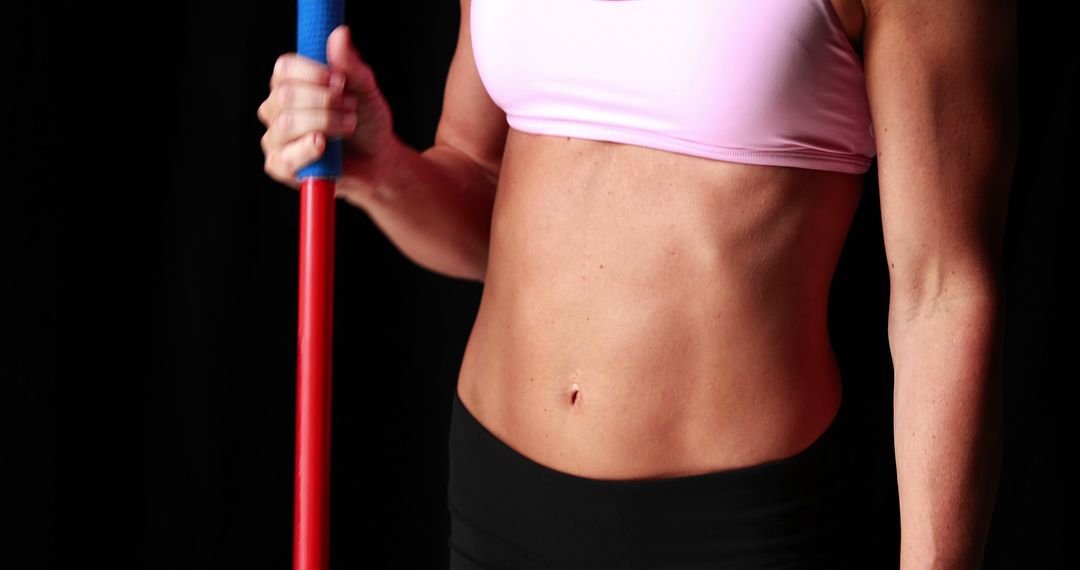 Athletic Woman Holding Exercise Stick in Gym - Free Images, Stock Photos and Pictures on Pikwizard.com