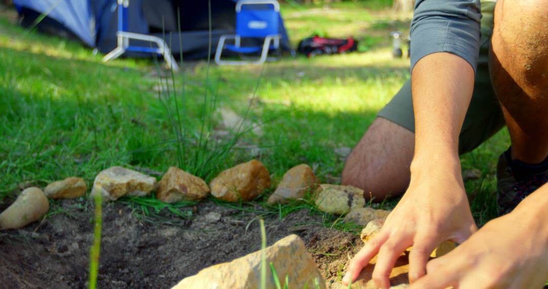 Person Building Fire Pit at Campsite - Free Images, Stock Photos and Pictures on Pikwizard.com