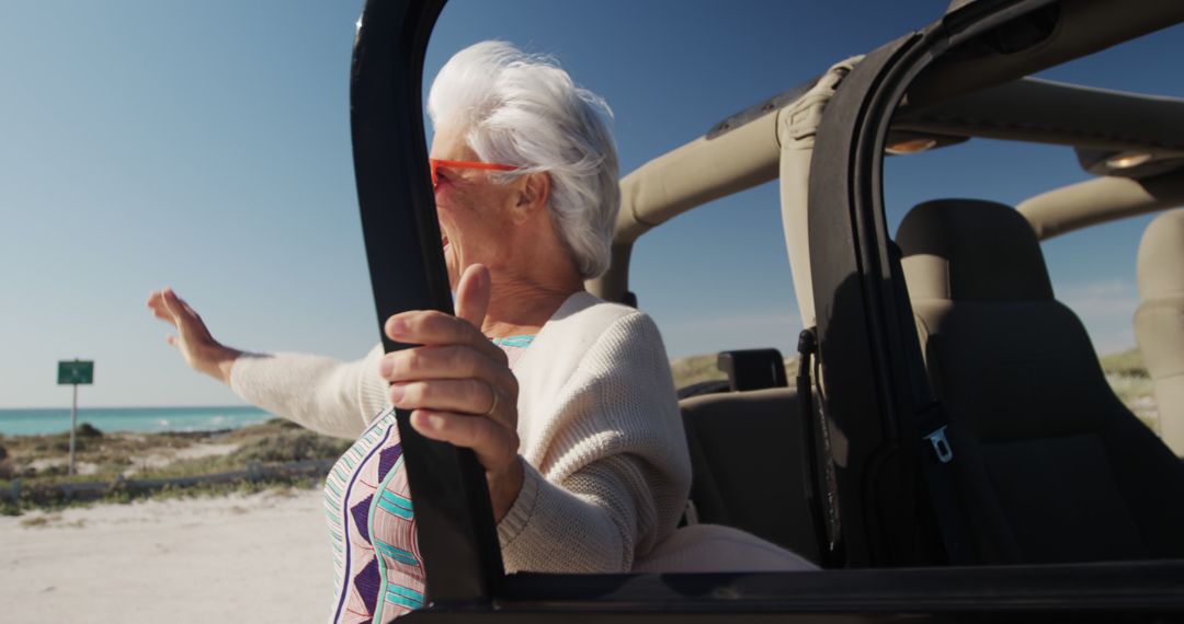 Senior Woman Enjoying Seaside Ride in Open Convertible - Free Images, Stock Photos and Pictures on Pikwizard.com