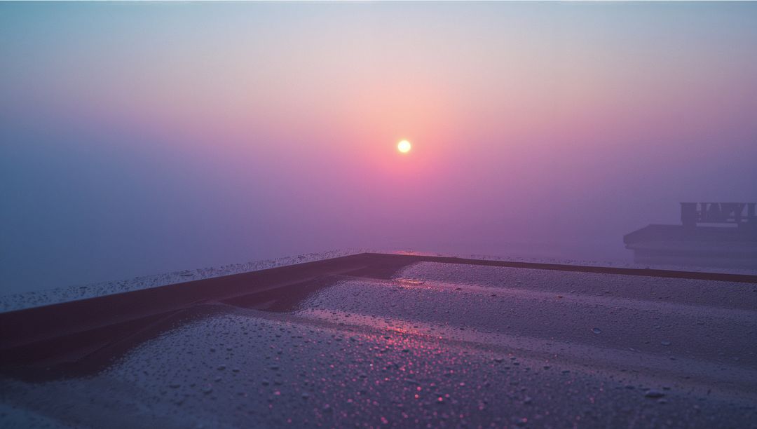 Serene Sunrise Over Misty Rooftop with Dewdrops