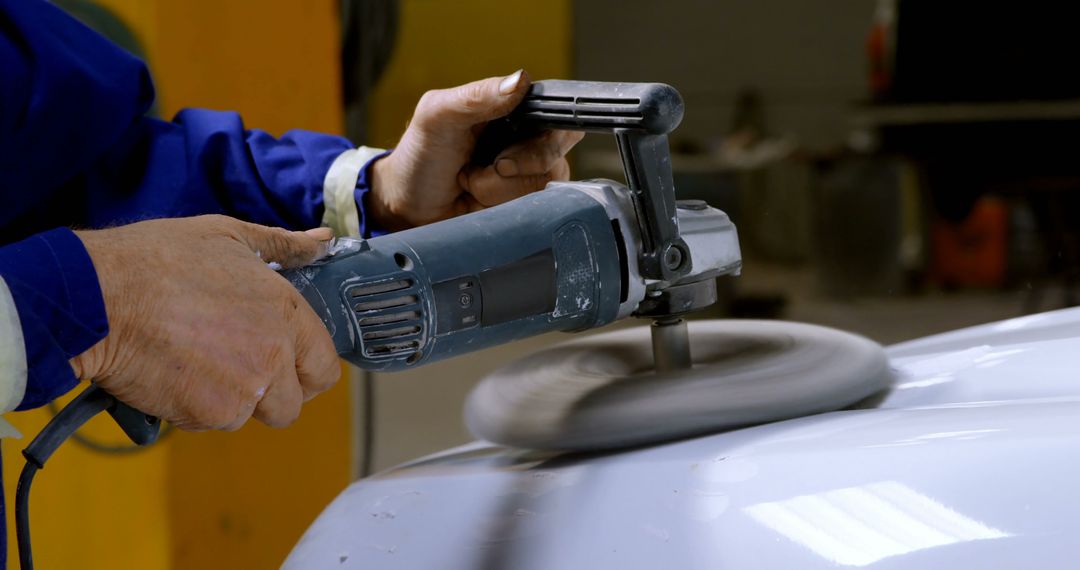 Close-up of Person Polishing Car with Electric Buffer in Workshop - Free Images, Stock Photos and Pictures on Pikwizard.com