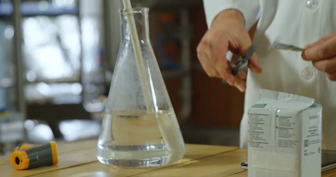 Scientist Conducting Experiment in Laboratory with Distilled Water and Tools - Free Images, Stock Photos and Pictures on Pikwizard.com