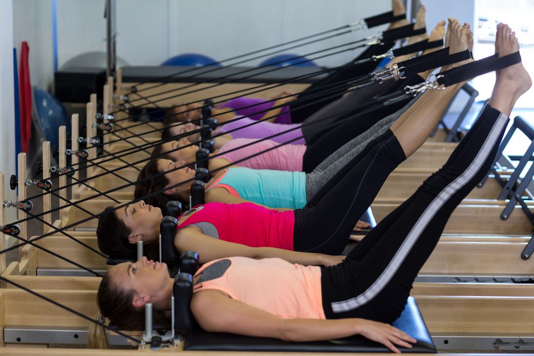 Group of women exercising on reformer - Free Images, Stock Photos and Pictures on Pikwizard.com