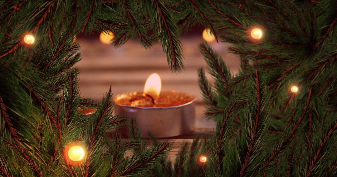 Cozy Christmas Setting with Fir Branches and Candlelight