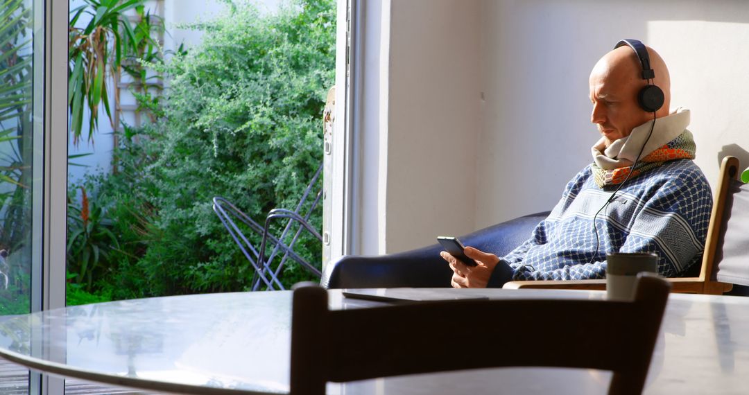 Caucasian Man Relaxing on Sofa Listening to Music