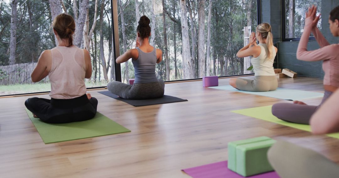 Women Practicing Yoga in Peaceful Studio - Free Images, Stock Photos and Pictures on Pikwizard.com