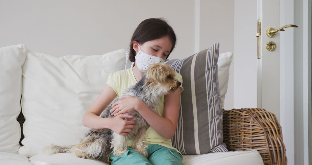 Young Girl Wearing Face Mask Hugging Pet Dog on Sofa - Free Images, Stock Photos and Pictures on Pikwizard.com