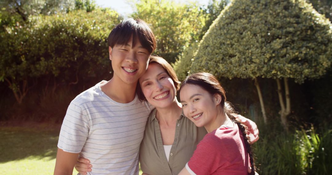 Smiling Family Enjoying Time Together Outdoors in Garden