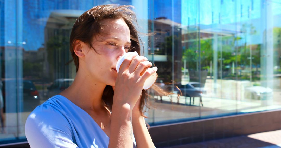 Young Woman Enjoying Coffee Outdoors - Free Images, Stock Photos and Pictures on Pikwizard.com