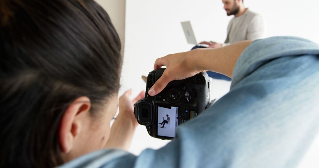 Photographer Capturing Subject with Laptop in Studio - Free Images, Stock Photos and Pictures on Pikwizard.com