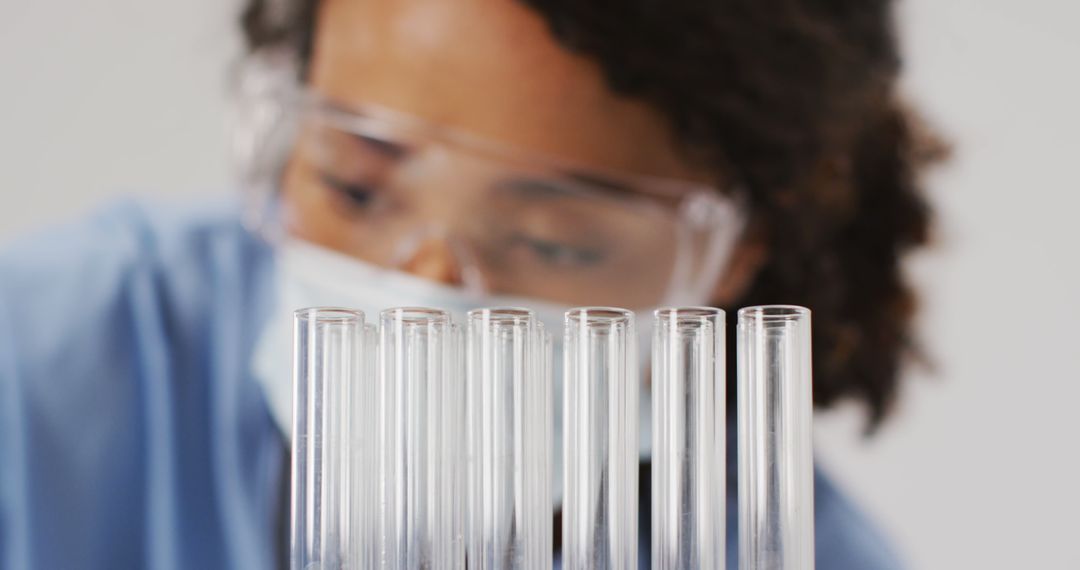 Scientist Examining Test Tubes in Laboratory - Free Images, Stock Photos and Pictures on Pikwizard.com