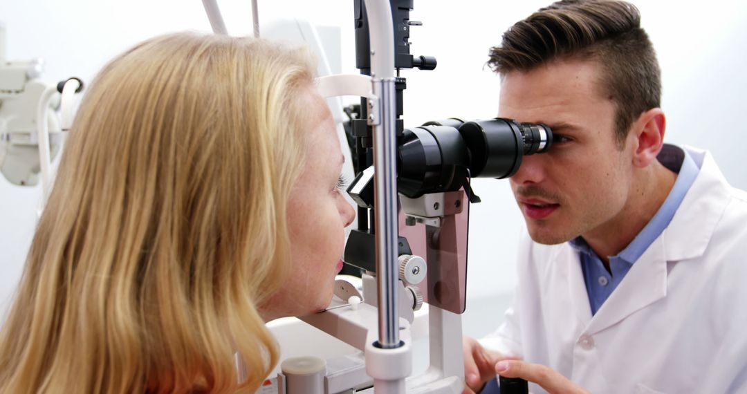 Optometrist Examining Woman's Eyes Using Slit Lamp in Clinic - Free Images, Stock Photos and Pictures on Pikwizard.com